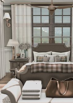 a bed room with a neatly made bed next to a chair and table in front of a window