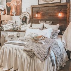 a bed room with a neatly made bed and pictures on the wall above it's headboard