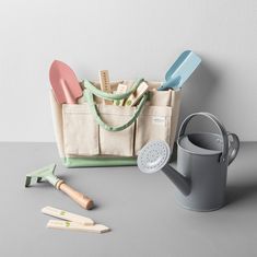 an assortment of kitchen utensils sitting on top of a table next to a bag