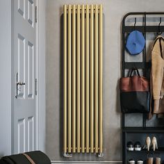 a large gold radiator next to a coat rack