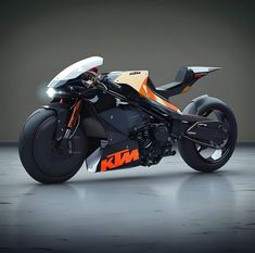 an orange and black motorcycle is parked in a dark room with no one around it