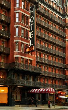 the hotel chelsea in new york city is red and white with balconies on it