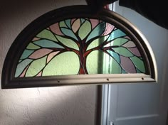 a stained glass window hanging from the side of a door