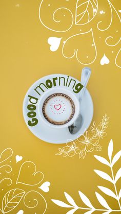 a cup of coffee sitting on top of a saucer with the word good morning written in it