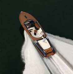 an aerial view of a speedboat speeding through the water