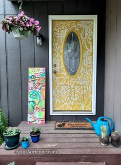 the front door is painted yellow and has potted plants