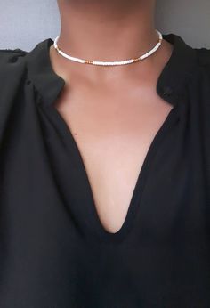 White and Gold Bead Choker - White Beaded Choker - Dainty Gold Choker - Seed Choker - Stretch Choker - Boho Bead Choker  * D E T A I L S * This choker is made with size 8 Seed Beads that are strung onto durable Stretch Cord.  * S I Z E * This choker is available in the following sizes: 11.5 inches 12 inches 12.5 inches 13 inches 13.5 inches 14 inches Each choker has a 2'' extender chain.  * Q U E S T I O N S *  If you have any questions, feel free to send me a message ♥ White Tiny Beads Choker For Beach, White Beaded Bohemian Choker, Bohemian White Beaded Chain Choker, White Beaded Chain Necklaces For Festivals, White Bohemian Beaded Chain Choker, White Beaded Necklace For Festivals, White Bohemian Beaded Choker, White Bohemian Choker With Beaded Chain, White Tiny Beaded Choker