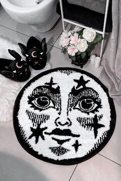 a black and white rug with a face on it