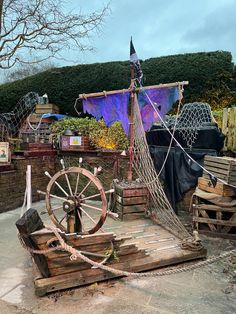 an old wooden boat wheel on display outside