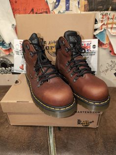 If you need or want a steel toed boot for work or just an everyday all rounder then these fit the bill. A Dr Martens boot that will last many a year due to the quality of both the leather and the sold, thicker, cushioned sole unit. The upper is a Teak Brown waxed leather,strong and extremely good in all weathers. They have a hiking style look with the metal d-rings and padded collar for extra support/ comfort. These boots are Made in Asia, but are of a very good build . They are a UK size 6, Eur Rugged Steel Toe Martin Boots, Rugged Martin Boots With Reinforced Toe For Outdoor Work, Casual Lace-up Safety Boots, Brown Steel Toe Martin Boots For Outdoor, Outdoor Brown Martin Boots With Steel Toe, Rugged Brown Martin Boots With Steel Toe, Reinforced Plain Toe Work Boots For Walking, Outdoor Brown Steel Toe Martin Boots, Sturdy Lace-up Boots For Outdoor Work