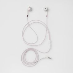 the ear buds are plugged in and attached to the headphones on the white surface