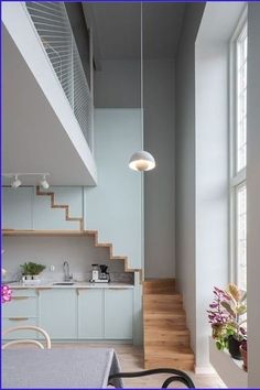 an open kitchen and stairs leading to the upper floor