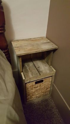 a small wooden table next to a bed