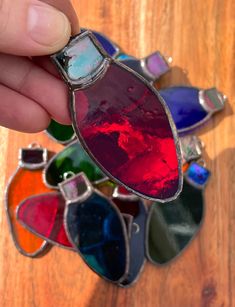 a person holding onto some colorful glass items