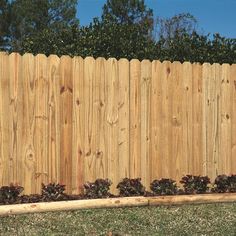 a wooden fence in the middle of a yard