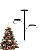 a small christmas tree is next to two lights and a lamp post on a white background