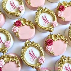 some pink and gold decorated cookies with roses on them