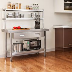 a kitchen with stainless steel shelving and wooden floors