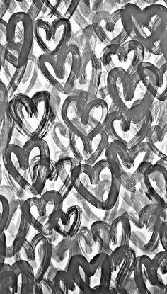 black and white photograph of hearts drawn in watercolor on paper, with the words love written