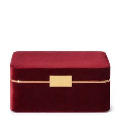 a red velvet box with gold trimmings on the top and bottom, sitting against a white background