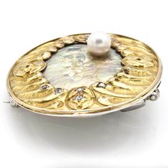 Weight: 23.3 Grams Stone: 6 mm Sea Pearl & 0.16 TCW Diamonds Measurements: 37.8 x 43.8 mm Tested: 14K Item #: BR-02-03 Luxury Engraved Brooch For Anniversary, Luxury White Gold Brooches Collectible, Luxury White Gold Collectible Brooch, Luxury White Gold Collectible Brooches, Luxury Engraved Yellow Gold Brooches, Luxury Round Brooches For Collectors, Luxury Round Collectible Brooches, Luxury Oval Brooches For Anniversary, White Gold Round Brooch For Anniversary