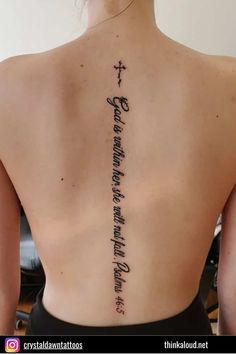 a woman with a cross tattoo on her back