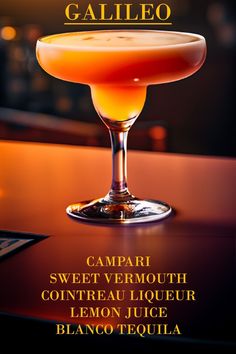 an orange cocktail in a coupe glass on a bar with the caption's name below it