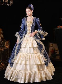 Imagining yourself as a queen stepping into a grand ballroom at prom? This regal blue and cream gown is your perfect choice. Crafted with meticulous attention to detail, the deep royal blue velvet is complemented by rich golden embroidery that adorns the bodice and majestic layers of the skirt. The cream sections of the gown shimmer with delicate embroidery, while the extensive ruffle detailing and lace trim around each tier amplify the dress's royal essence. This gown comes with a matching blue velvet jacket trimmed in gold, enhancing the luxurious feel. Perfect for anyone who dreams of making a grand, unforgettable entrance, this dress promises to turn heads and capture hearts. Era Victoria, Baroque Dress, Costume Carnaval, Womens Cosplay, Princess Prom Dresses, Royal Blue Prom Dresses, Cinderella Dresses, Flare Sleeves, Medieval Dress