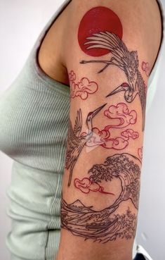 a woman with a tattoo on her arm that has a bird flying over the waves