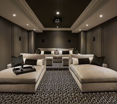 an image of a home theater with couches and tables in the room that is empty