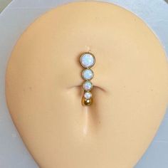 a white and gold ring sitting on top of a mannequin's head