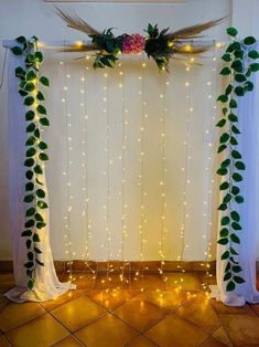 an arch decorated with greenery and lights for a wedding or reception ceremony at the same time