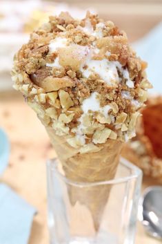 an ice cream cone with nuts and yogurt on top