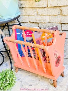 an orange magazine rack with magazines in it