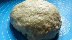 a ball of dough sitting on top of a blue plate