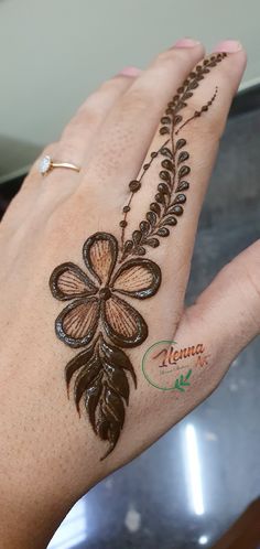 a woman's hand with henna tattoos on it