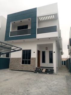 a white and blue two story house with black shutters