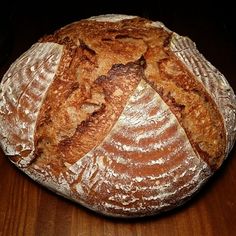 a loaf of bread sitting on top of a wooden table