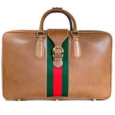 Gucci vintage brown leather luggage with iconic canvas red/green stripes motif, signed/carved golden metal hardware and keys and travel tag still with the Gucci label.. brand new and never used, always kept by the owner in a dustbag it remained perfect as you would expect it from the Gucci boutique at the time. part of a set of three luggages we will list, all of them brand new and with the same design but different sizes and shapes. 2 sizes available smaller: 40x 70 x 20 cm larger: 45x 75 x 23 Gucci Label, Gucci Boutique, Travel Tags, Gucci Vintage, Leather Luggage, Suitcase Traveling, Suitcases, Metal Hardware, Vintage Brown