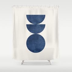 a white shower curtain with blue circles on it