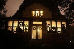 a house decorated for halloween with decorations on the windows