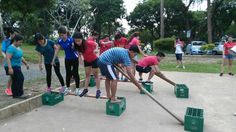 a group of people standing around each other with buckets and shovels in front of them