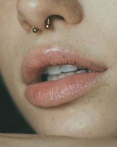 a woman with piercings on her nose