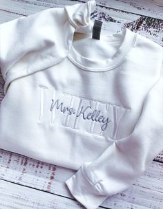 Wifey Sweatshirt-Wife Sweatshirt-Engagement Gift-Wedding Gift-Future Mrs Sweatshirt-Mrs Sweatshirt-Bride Sweatshirt-Embroidered Sweatshirt-Custom Embroidered Sweatshirt-Wife Sweatshirt-Wedding Gift for Her Custom Wifey Sweatshirt Embroidered with your choice of FUTURE, BRIDE, WIFEY or WIFE. This unisex sized custom sweatshirt is super soft and makes an elegant Wifey sweatshirt for you to wear or a wonderful engagement gift for any Wifey or Future Mrs! Perfect for a Bachelorette Party or to wear White Long Sleeve Sweatshirt With Letter Embroidery, White Fitted Cotton Sweatshirt, White Long Sleeve Top With Custom Embroidery, White T-shirt With Embroidered Text For Winter, White Long Sleeve T-shirt With Embroidered Text, Fitted White Tops With Embroidered Text, White Long Sleeve Wedding Sweater, White Crew Sweatshirt With Embroidered Text, White Crew Neck Sweater With Letter Embroidery