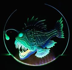 a fish is glowing in the dark with its mouth open