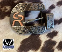 Handcrafted custom belt buckle. Each piece is carefully crafted by Duayne in the great state of Texas.  Overlays are available in Silver, Copper, or a combination. "Each piece tells a story and takes on a life of its own. It starts with the raw material and then turns into a handcrafted work of art special to each customer." Duayne Williams There are several styles to choose from. Please see the photo of the styles available and indicate which letter style you would like.  Most buckles are 1 1/2 Custom Engraved Belt Buckles For Formal Occasions, Custom Belt Buckles, Cowboy Belt Buckles, Cattle Brands, Western Belt Buckles, State Of Texas, Custom Belt, Rodeo Cowboy, Western Belt