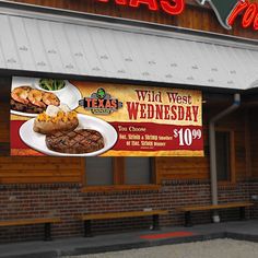 a restaurant with a sign advertising steaks on the front