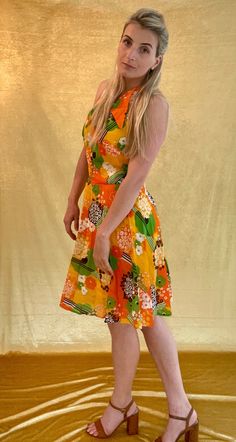 A Bright orange/yellow/green 60s printed chiffon sleeveless dress. The ideal festival/wedding halter neck dress. It's Shown on a Medium sized model. Chest measures 35 inches and total length is 36 inches. In good vintage condition. Orange Halter Neck Sleeveless Dress For Summer, Orange Summer Halter Neck Dress, Orange Halter Neck Dress For Summer, Retro Sleeveless Halter Dress For Summer, Fitted Retro Sleeveless Halter Dress, Yellow Floral Print Sleeveless Party Dress, Retro Dress With Orange Retro Print, Orange Retro Dress With Retro Print, Orange Dress With Retro Print