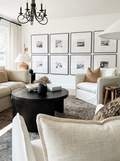 a living room filled with furniture and pictures on the wall