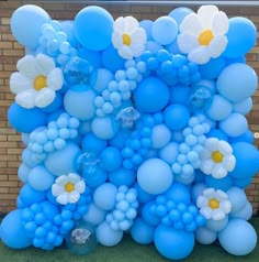 blue and white balloons are arranged in the shape of flowers on display at an outdoor event